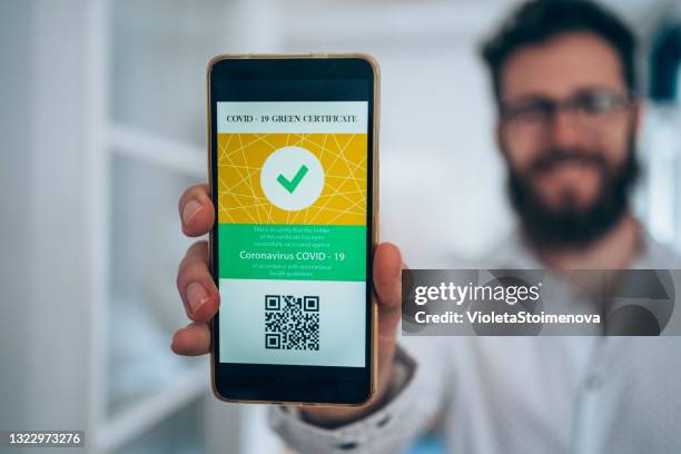 digital international certificate of covid-19 vaccination. - man showing phone stock pictures, royalty-free photos & images