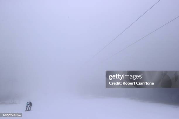 Two women are seen on the snow on June 11, 2021 in Mount Buller, Australia. Mt Buller Ski Resort will open for the snow season on Saturday 12 June....