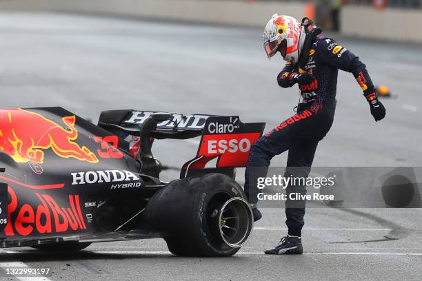 Max Verstappen of Netherlands and Red Bull Racing kicks his tyre as he reacts after crashing during the F1 Grand Prix of Azerbaijan at Baku City...