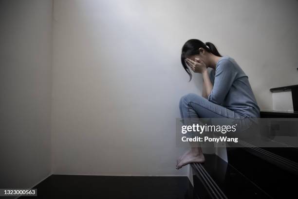 het vrouwelijke gepeste zit op trap - geestelijke mishandeling stockfoto's en -beelden