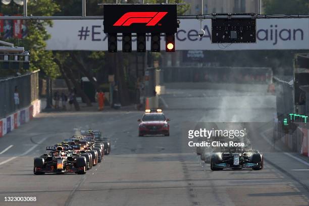Lewis Hamilton of Great Britain driving the Mercedes AMG Petronas F1 Team Mercedes W12 awaits the restart with over heating brakes following a red...