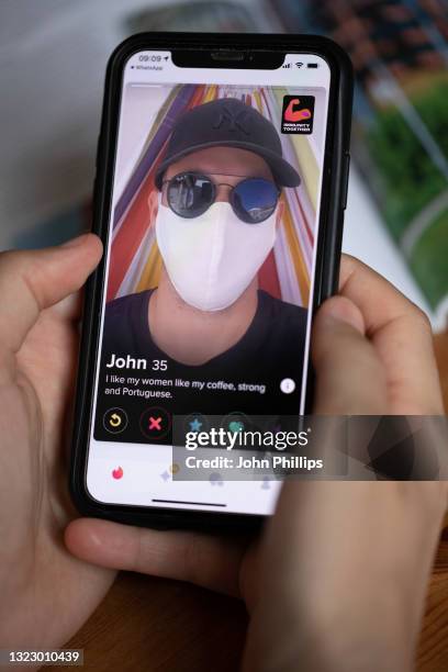 In this photo illustration, A covid vaccine sticker is seen displayed on the photographer’s Tinder dating app profile on June 11, 2021 in London,...