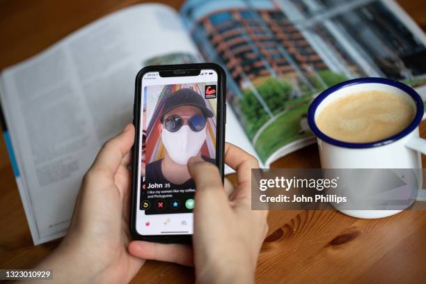 In this photo illustration, A covid vaccine sticker is seen displayed on the photographer’s Tinder dating app profile on June 11, 2021 in London,...