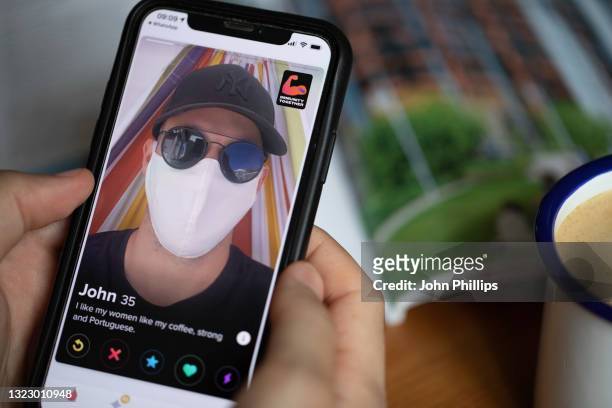 In this photo illustration, A covid vaccine sticker is seen displayed on the photographer’s Tinder dating app profile on June 11, 2021 in London,...