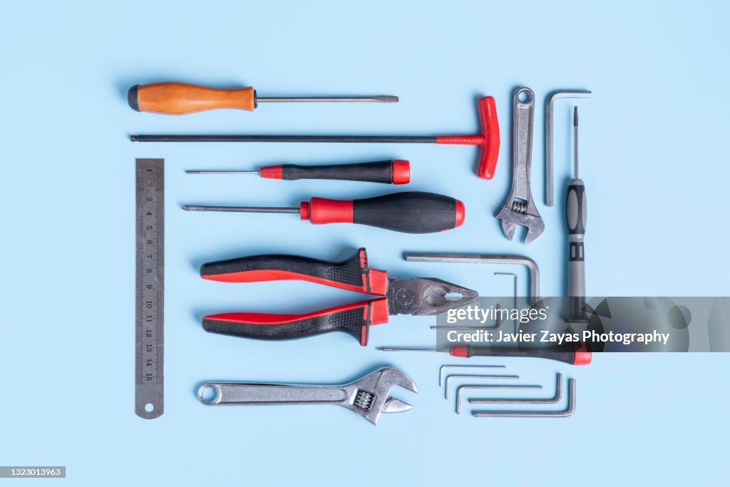 Working Tools Arranged On Blue Background