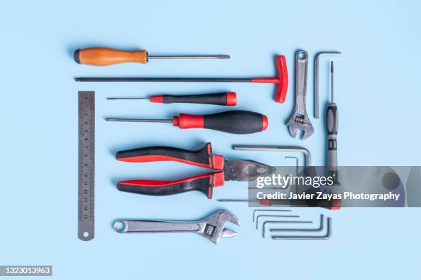 working tools arranged on blue background - tools essentials photos et images de collection