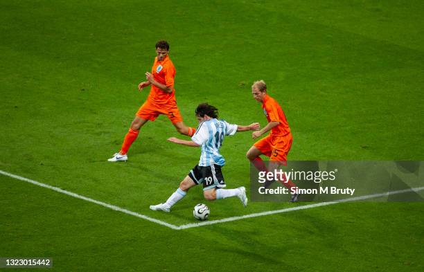 Lionel Messi of Argentina, Khalid Boulahrouz and Tim de Cler of Netherlands in action during the FIFA World Cup Group C match between Netherlands and...