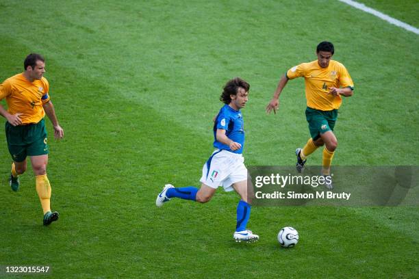 Andrea Pirlo of Italy and Tim Cahill and Mark Viduka of Australia in action during the FIFA World Cup round of 16 match between Italy and Australia...