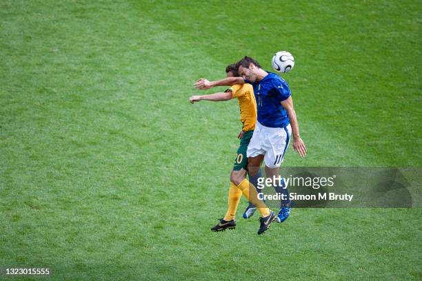 Alberto Gilardino of Italy and Luke Wilkshire of Australia in action during the FIFA World Cup round of 16 match between Italy and Australia at the...