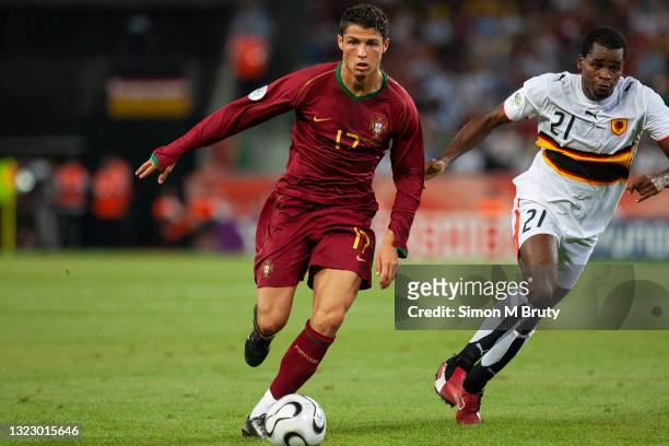 Cristiano Ronaldo of Portugal and Delgado of Angola in action during the FIFA World Cup Group D match between Portugal and Angola at the Rhein...