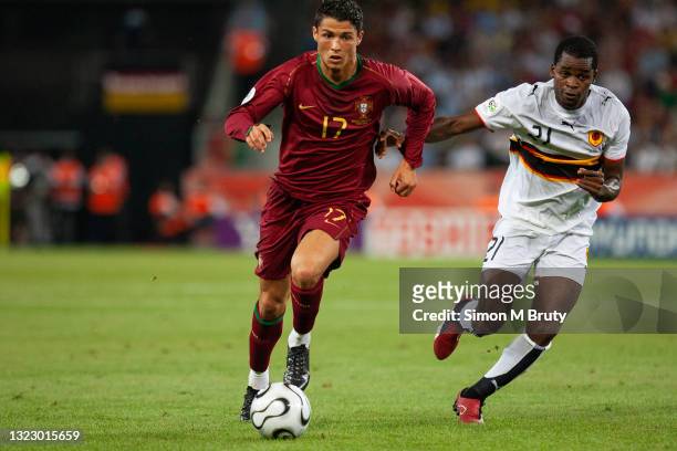 Cristiano Ronaldo of Portugal and Delgado of Angola in action during the FIFA World Cup Group D match between Portugal and Angola at the Rhein...