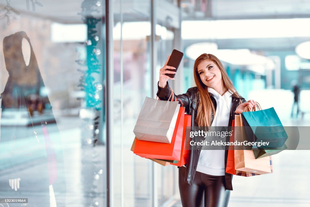Selfie Time For Beautiful Female Shopping In Mall