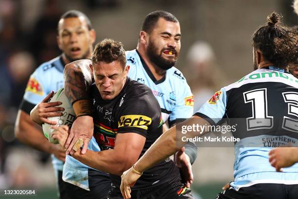 Scott Sorensen of the Panthers is tackled high by Andrew Fifita of the Sharks during the round 14 NRL match between the Cronulla Sharks and the...
