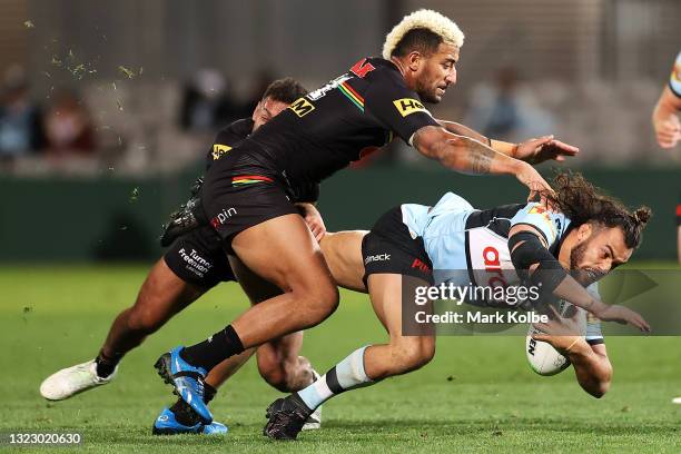 Toby Rudolf of the Sharks is tackled during the round 14 NRL match between the Cronulla Sharks and the Penrith Panthers at Netstrata Jubilee Stadium,...