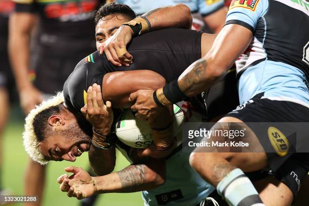 Viliame Kikau of the Panthers is tackled during the round 14 NRL match between the Cronulla Sharks and the Penrith Panthers at Netstrata Jubilee...