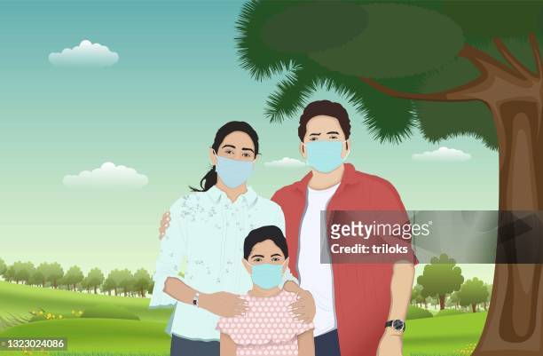 family with protective face mask at park - indian mother stock illustrations