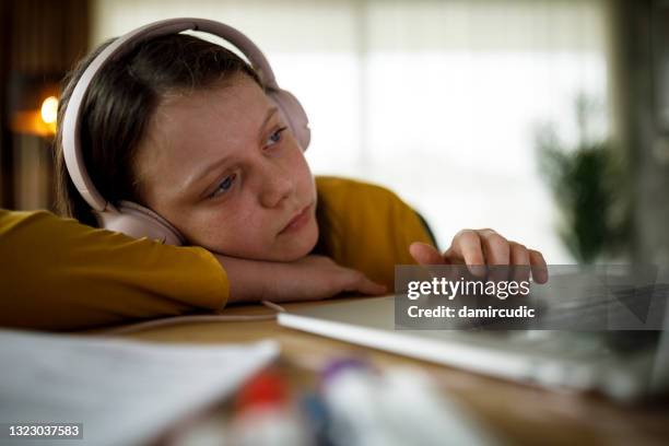 bored school girl having online class - unhappy school child stock pictures, royalty-free photos & images