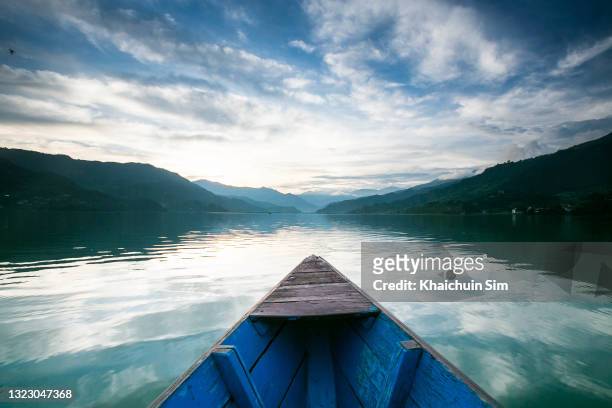 boat in the middle of a reflection lake - canoe ストックフォトと画像