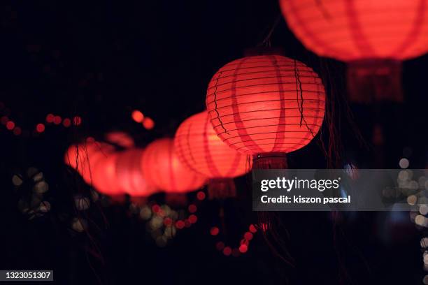 red paper chinese lanterns illuminated at night - chinese lantern fotografías e imágenes de stock