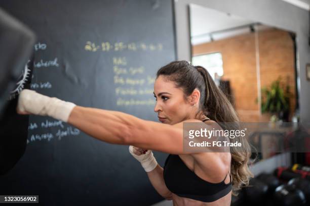confident female boxer practicing at the gym - persistence stock pictures, royalty-free photos & images