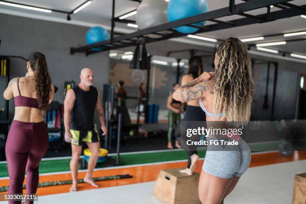 group of woman during circuit training at a gym - cardiovascular exercise stock pictures, royalty-free photos & images