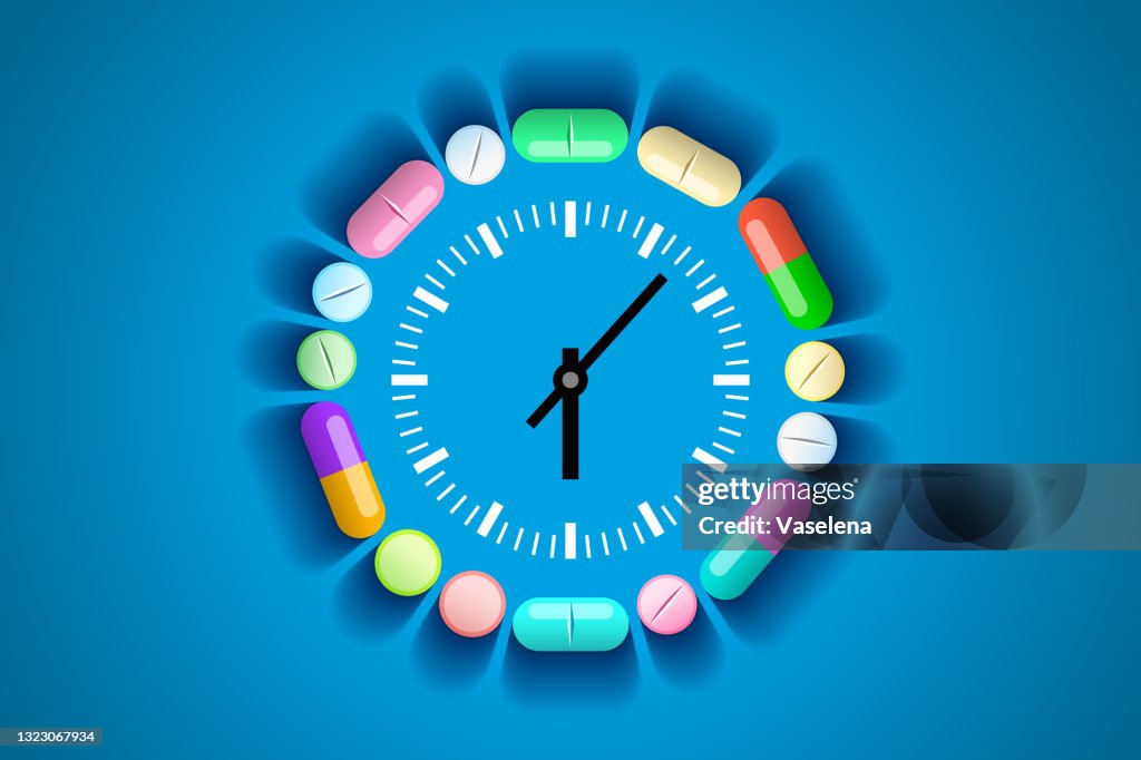 Clock and pills and tablets around it, healthcare and medical concept