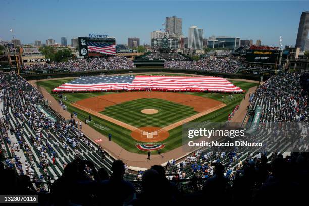 Flag is unfurled on the field prior to a game between the Chicago Cubs and the St. Louis Cardinals at Wrigley Field on June 11, 2021 in Chicago,...