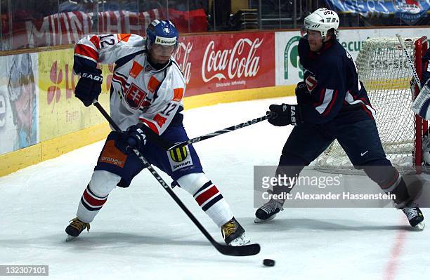 Rene Skoliak of Slovakia race for the puck against Yan Stastny of USA during the German Ice Hockey Cup 2011 first round game between Slovakia and USA...