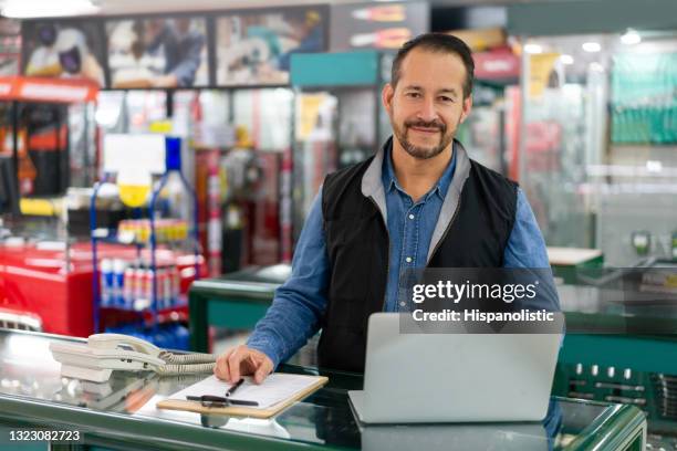 bedrijfs manager die gelukkig het werken bij een ijzerhandel kijkt - retail occupation stockfoto's en -beelden