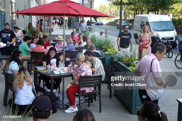 People gather for lunch at a restaurant on Michigan Avenue on June 11, 2021 in Chicago, Illinois. Today Chicago and the rest of the state of Illinois...