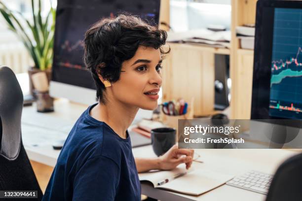 latin american businesswoman analyzing company's financial data on a pc - investment manager stock pictures, royalty-free photos & images