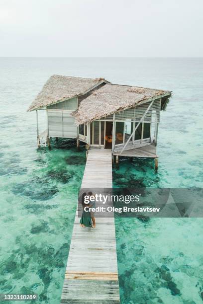 couple in love kissing near luxury hotel with ocean and coral reef view. romantic honeymoon in asia - honeymoon stock pictures, royalty-free photos & images