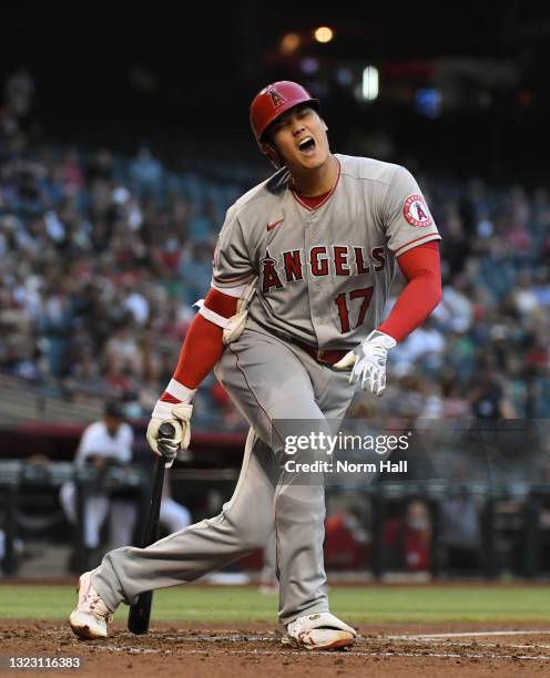 Shohei Ohtani of the Los Angeles Angels reacts after hitting a foul ball off of his knee during the third inning against the Arizona Diamondbacks at...