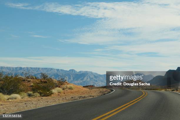 roadway in deserted mountains - nevada stock pictures, royalty-free photos & images