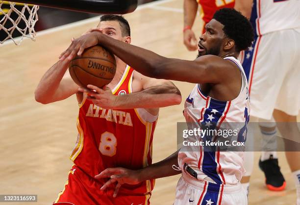 Joel Embiid of the Philadelphia 76ers strips the ball from Danilo Gallinari of the Atlanta Hawks during the second half of game 3 of the Eastern...