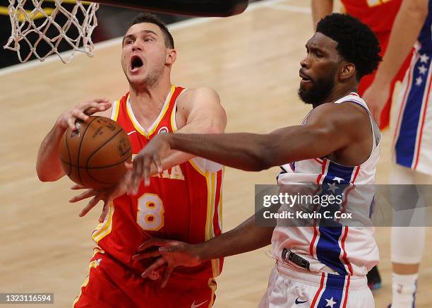 Joel Embiid of the Philadelphia 76ers strips the ball from Danilo Gallinari of the Atlanta Hawks during the second half of game 3 of the Eastern...