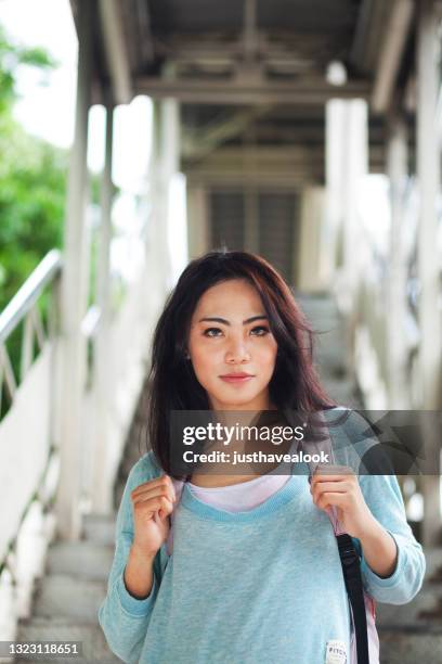 pretty filipina transgender is coming down steps of pedestrian bridge - beautiful filipina stock pictures, royalty-free photos & images