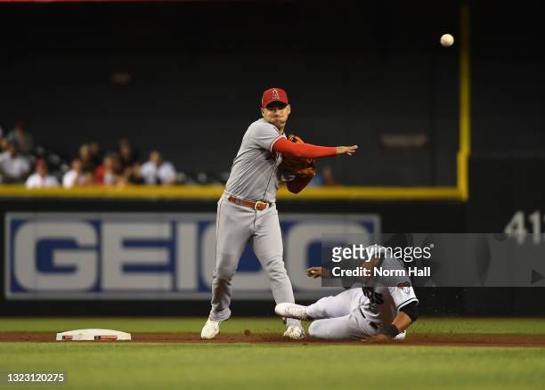 Jose Iglesias of the Los Angeles Angels attempts to turn a double play on a ground ball hit by Pavin Smith of the Arizona Diamondbacks as Eduardo...
