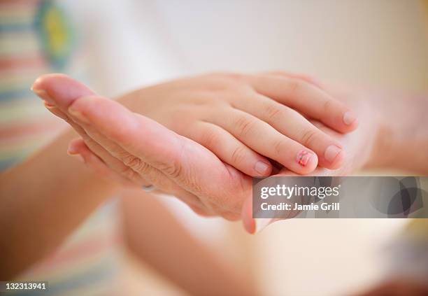 mother and daughter's hands, close-up - mother daughter holding hands stock pictures, royalty-free photos & images