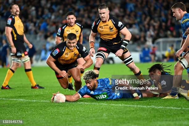 Hoskins Sotutu of the Blues dives over to score a try during the round five Super Rugby Trans-Tasman match between the Blues and the Western Force at...