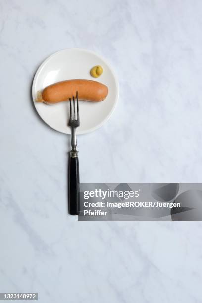 cervelat with mustard and fork on plate, meat sausage, switzerland - cervelat stock pictures, royalty-free photos & images