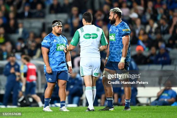 Patrick Tuipulotu of the Blues looks on as referee Ben O'Keeffe gives Ray Niuia of the Blues a yellow card during the round five Super Rugby...