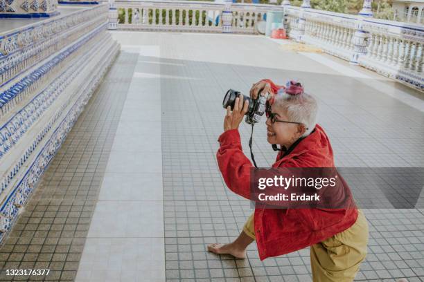 zctive senior photographer working at temple-stock photo - eccentric stock pictures, royalty-free photos & images
