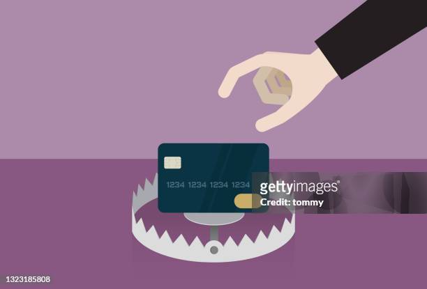 geschäftsmann wählt eine kreditkarte in einer falle - money to burn stock-grafiken, -clipart, -cartoons und -symbole