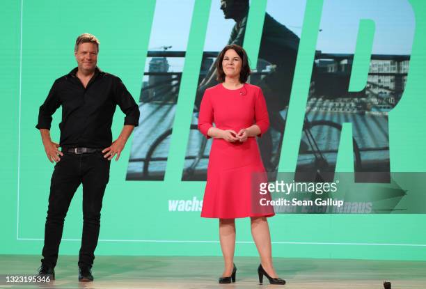Annalena Baerbock and Robert Habeck, co-heads of the German Greens Party, smile after delegates at the Greens Party virtual party congress confirmed...