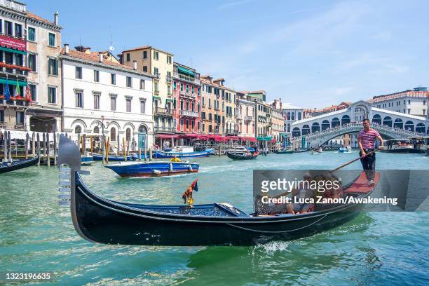 Tourists enjoy a gondola ride on June 12, 2021 in Venice, Italy. International tourists started to travel again after the Covid-19 pandemic, as more...