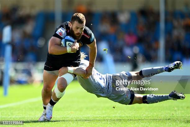 Luke Cowan-Dickie of Exeter Chiefs is tackled by Faf de Klerk of Sale Sharks during the Gallagher Premiership Rugby match between Exeter Chiefs and...
