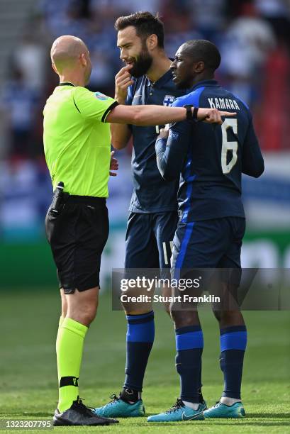 Match Referee, Anthony Taylor speaks with Tim Sparv and Glen Kamara of Finland during the UEFA Euro 2020 Championship Group B match between Denmark...
