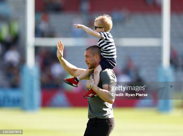 Mike Brown of Harlequins reacts with his son after a presentation to mark the end of his Harlequins career during the Gallagher Premiership Rugby...