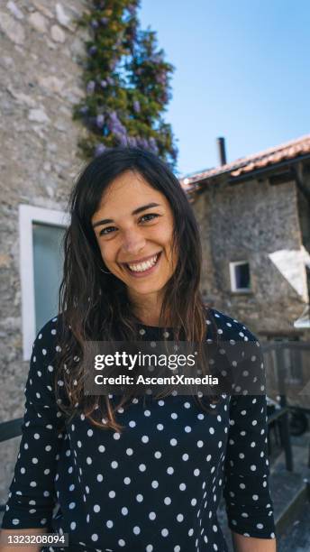 young woman walks down cobblestone streets of lugano - lugano switzerland stock pictures, royalty-free photos & images